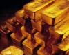 Gold slips as US dollar strengthens, investors await Fed officials comments; silver trades flat