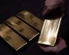 Gold edges down as US dollar firms